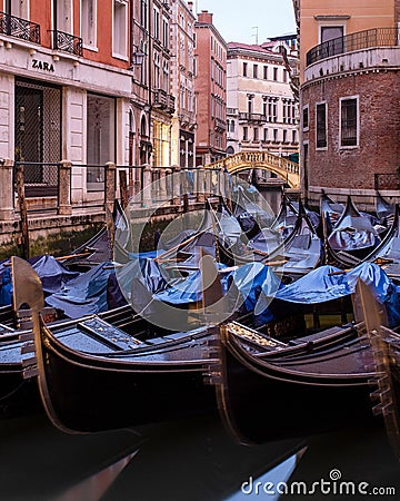 Vertical shot of beautiful gondolas in canal in Venice, Italy Editorial Stock Photo