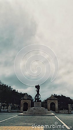 Vertical shot of a beautiful statue in a square in Malta captured on a cloudy day Editorial Stock Photo