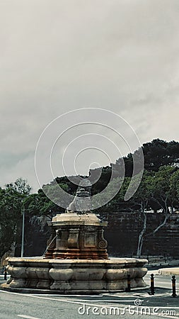 Vertical shot of a beautiful statue in a square in Malta captured on a cloudy day Editorial Stock Photo