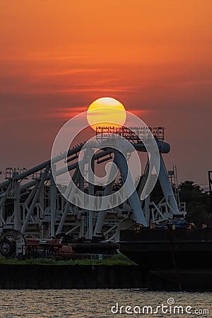 Vertical shot of a beautiful sunset over an industrial structure in Tuxpan, Veracruz, Mexico Stock Photo