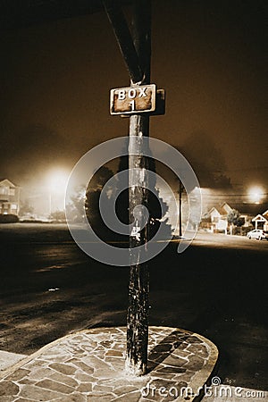 Vertical shot of a black pole with a sign that says Editorial Stock Photo