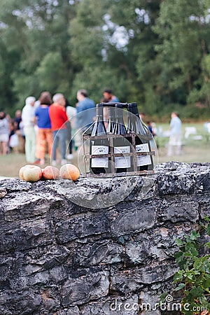 Vertical shot of bottles of wine on a rock wall. Editorial Stock Photo