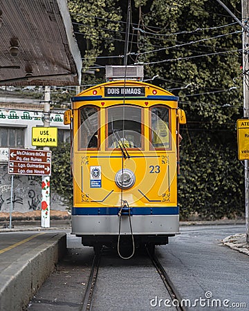 Vertical shot of a bright yellow streetcar at Santa Teresa, Rio de Janeiro Editorial Stock Photo