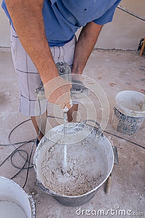 Vertical shot of a builder preparing the cement Stock Photo