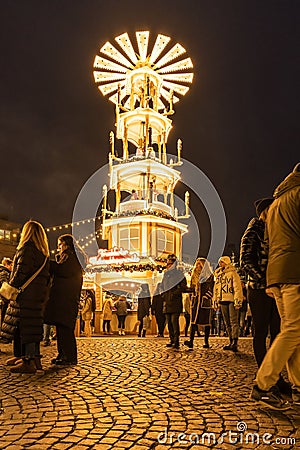 Vertical shot of a Christmas pyramid in Rossmarkt Christmas market at night, Frankfurt, Germany Editorial Stock Photo