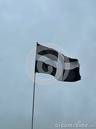 Vertical shot of the Cornwall flag waving in the sky Stock Photo