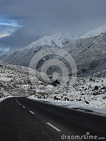 Vertical shot of a curvy highway road in the snowy mountains in New Zealand Southern Alps Stock Photo