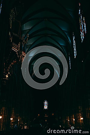 Vertical shot of the dark hallway inside Notre Dame Cathedral captured in Strasbourg, France Editorial Stock Photo