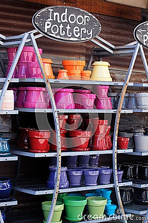 Vertical shot of decorative colorful indoor pottery in the shelfs Stock Photo