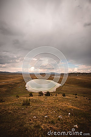 Vertical shot of the Devil lake in the mountains of Durmitor in Zabljak, Montenegro Stock Photo