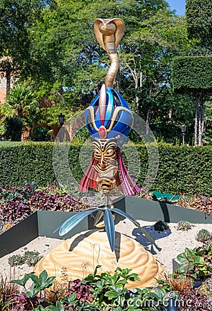 Vertical shot of a Disney cartoon character Jafar sculpture in a garden in Disneyland, France Editorial Stock Photo