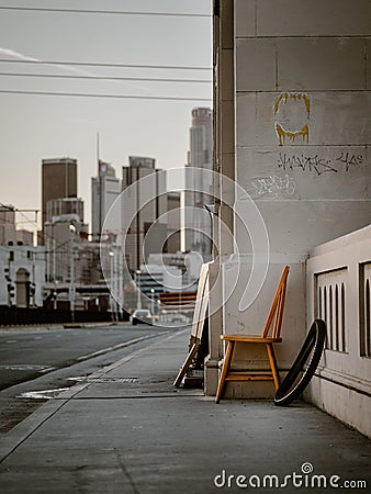 Vertical shot of dramatic scene with a chair on the sidewalk of Los Angeles streets, CA, USA Editorial Stock Photo