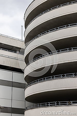 Vertical shot of a driveway of a parking ramp from outside in cloudy sky background Stock Photo
