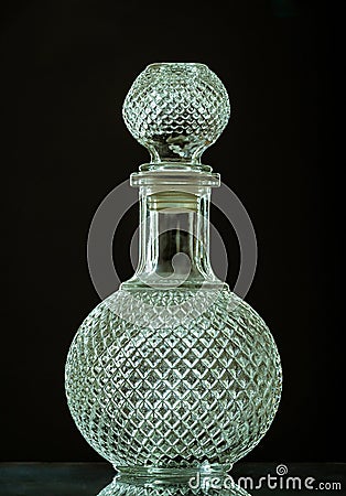 Vertical shot of an empty vintage decanter isolated on a black background Stock Photo