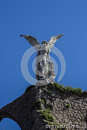 Vertical shot of Exterminating Angel located in the cemetery of Comillas Stock Photo