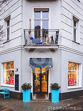 Vertical shot of the facade of a beautiful toyshop with toys behind the windows and on the balcony Editorial Stock Photo