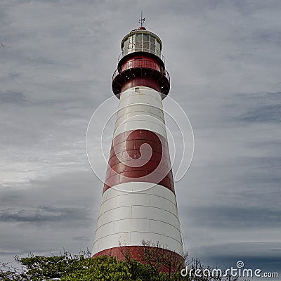 Vertical shot of a Faro De La Memoria Mar lighthouse with cloudy sky in the background in Argentina Stock Photo