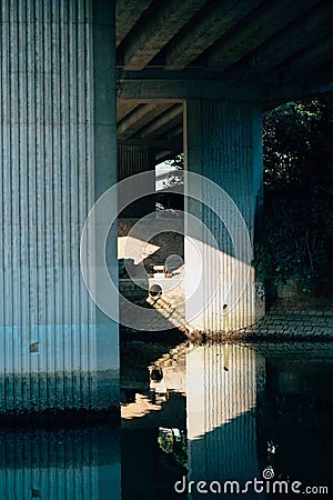 Vertical shot of the foundation of a bridge over the canal Stock Photo