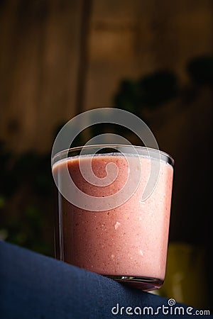 Vertical shot of a fresh strawberry smoothie in a simple glass cup Stock Photo
