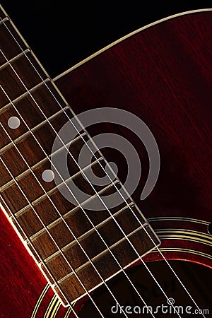 Vertical shot of fretboard of acoustic guitar Stock Photo