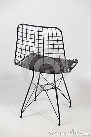 Vertical shot of a futuristic chair with a chain in the back behind a white background Stock Photo