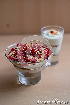 Vertical shot of a glass bowl of vanilla yogurt with currants on top on a beige background Stock Photo