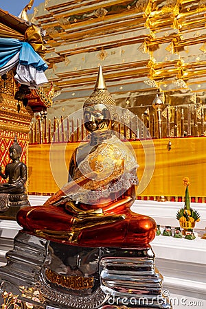 Vertical shot of a golden statue of Buddha in a temple Editorial Stock Photo