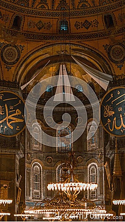 Vertical shot of Hagia Sophia with glowing chandeliers inside the historic mosque Editorial Stock Photo