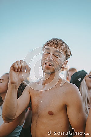 Vertical shot of a happy young male during electronic music festival Electrifinity in Bad Aibling Editorial Stock Photo