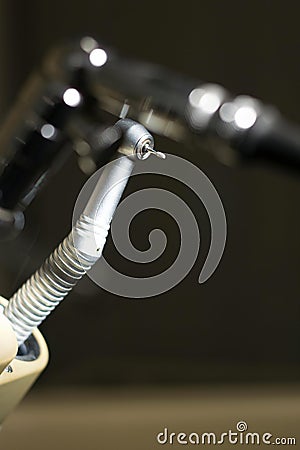 Vertical shot of a high-speed handpiece on a stand in a dental clinic with a blurry background Stock Photo