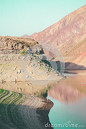 Vertical shot of hills reflecting on Azat Reservoir on a sunny day in Ararat, Armenia Stock Photo