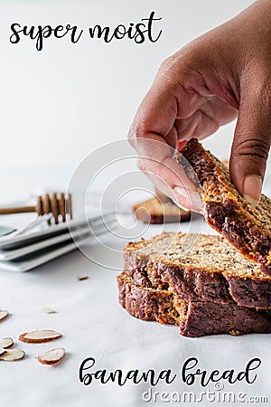Vertical shot of human hand touching bread with banana bread and super moist writings Stock Photo