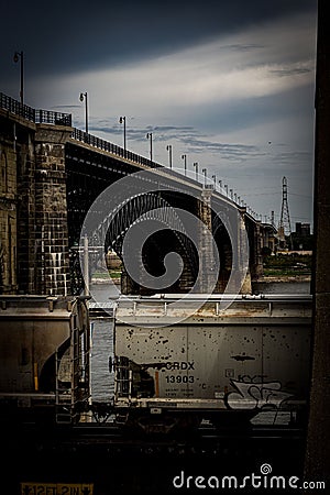 Vertical shot of an industrial train and a bridge in St Louis, United States in moody colors Editorial Stock Photo