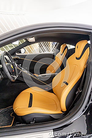 Vertical shot of an interior view of a Ferrari Roma with orange leather seats Editorial Stock Photo