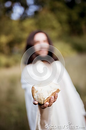 Vertical shot of Jesus Christ handing out bread with a blurred background Stock Photo