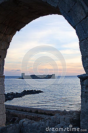Vertical shot of Korykos Castle seen trhough arch during the sunset Stock Photo
