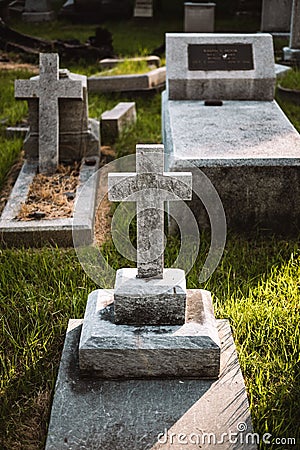 Vertical shot of a large white stone cross situated in a cemetery Editorial Stock Photo