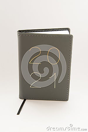 Vertical shot of a leather journal with 2021 writing on the cover on a white background Stock Photo