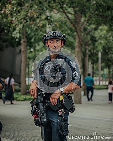 Vertical shot of a male security agent with guns and equipment in the streets of New York Editorial Stock Photo