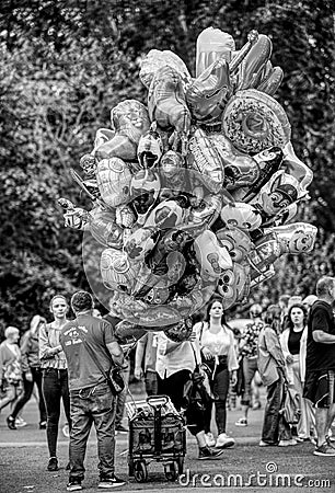 Vertical shot of a male selling air balloons in Halle an der Saale, Saxony-Anhalt, Germany Editorial Stock Photo