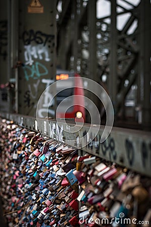 Vertical shot of many of padlocks hanging on Hohenzollern Bridge in Cologne, Germany Editorial Stock Photo
