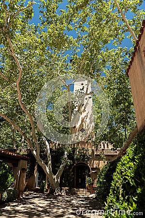 Vertical shot of a Mediterranean-style courtyard with lots of trees. Stock Photo