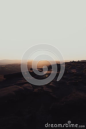 Vertical shot of the mesmerizing sunset over the rocky hillside Stock Photo