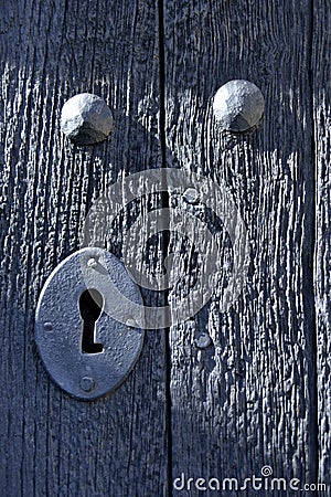 Vertical shot of a metal keyhole on the wooden door Stock Photo