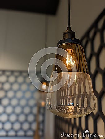 Vertical shot of the mini modern hanging torch with an abstract pattern background Stock Photo