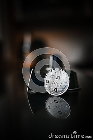 Vertical shot of nespresso capsules on a dark blurred background Editorial Stock Photo