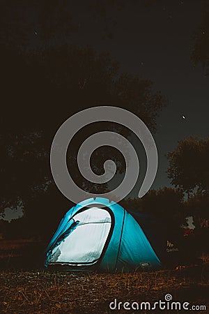 Vertical shot of Night time of the sky with stars and illuminated tent in Alcacer do Sal, Portugal Editorial Stock Photo