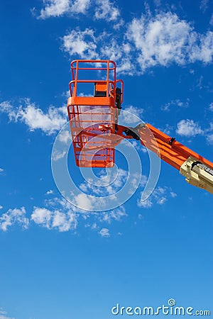 Vertical Shot of an Orange Hydraulic Construction Lift Stock Photo