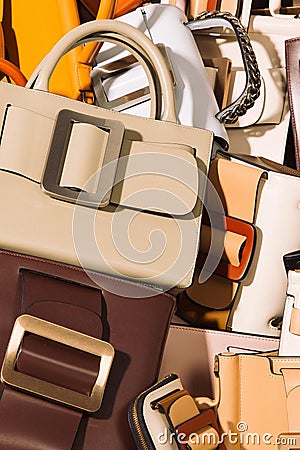 Vertical shot of a pile of fashion leather handbags Stock Photo