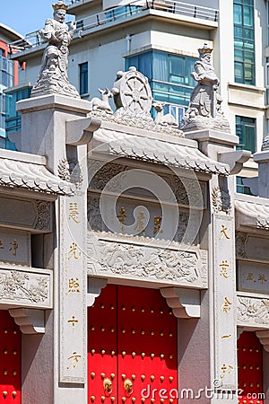 Vertical shot of the Pilu Temple in China standing against a background of a modern building Editorial Stock Photo